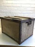 Front and side view of trunk showing canvas sides, metal edges, wear