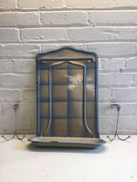 Front view of enamel utensil rack and two chrome hooks