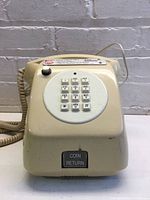 Front view showing keypad, coin return button and handset cord