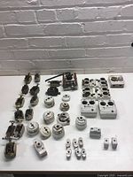 All porcelain electrical components laid out on tabletop