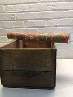 Wallpaper roll resting on wooden crate showing California Fruit Exchange stencilling