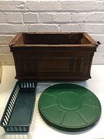 Group shot of wooden planter, green reel case, blue tray