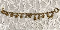 Full view of bracelet showing all twelve charms and clasp