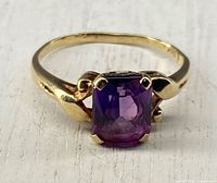 Front view of 14k gold ring with purple sapphire