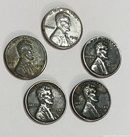 Obverse view of five 1943 steel Lincoln wheat cents