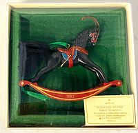 Front view of Hallmark 1982 rocking horse ornament in box