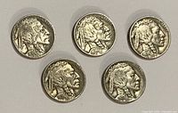 Obverse view of all five Buffalo nickels; dates and wear visible