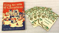 Front covers of large "Sing We Now of Christmas" booklet and four small "Christmas Carols" pamphlets