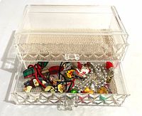 Box with lower drawer open showing liners and assorted jewelry inside