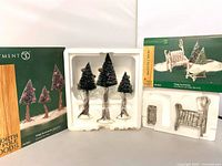 boxed set of three pine trees and boxed birch bench/table with contents displayed in foam