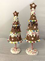 Front view of both gingerbread tree figurines on bases