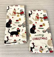 Both folded towels showing cat Christmas pattern