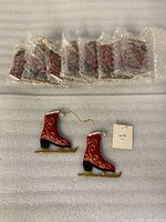 Eight bubble-wrapped pairs plus two unwrapped ornaments showing design