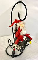 Front view Santa on polka-dot bird hanging from stand