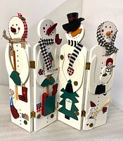 Full view of four connected snowman panels standing upright