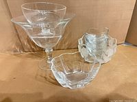 Group shot of all clear glass bowls and compote