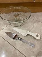 Glass pedestal cake stand with both cake servers