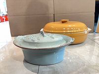 Both casseroles side by side showing overall style, lids, and colors