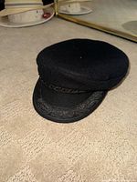 Front and side view of black wool Greek fisherman cap