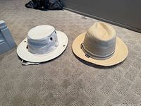 Both hats side by side on floor, showing overall styles and colors