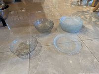 Stacks and singles of bowls and plates on floor