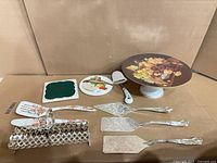 All items laid out including cake stand, servers, spatulas, trivets, lattice holder