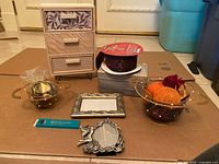 Overview of all items laid out: mini dresser, ribbon spool, frames, baskets, sewing notions