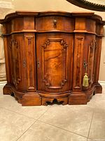 Front view of rococo sideboard showing drawer, doors, carving, base