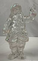 Full view of clear acrylic Santa figure standing upright