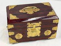 Full view of closed jewelry box showing brass mounts and latch