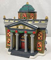 Front view of porcelain library building with columns and snow accents