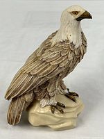 Full view of ceramic eagle figurine on rock base