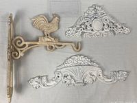 Overall view of three painted metal pieces