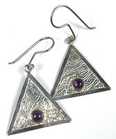 Front view of both triangular sterling silver earrings showing hammered texture and purple cabochons