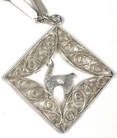 Close-up of diamond-shaped filigree pendant front
