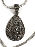 Front view of teardrop pendant showing marcasite and filigree detail on snake chain