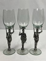 Three Ngwenya figural stem wine glasses full view