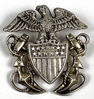 Front view of sterling U.S. Navy officers pin showing eagle, shield, crossed anchors