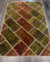 Full view of entire Persian patchwork rug on floor