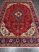 Full view of Persian Tabriz rug showing overall pattern and fringe