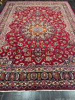 Full view of rug showcasing field, borders and colours