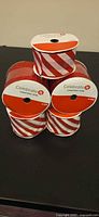 Five rolls Celebrate It red/white striped wired ribbon stacked