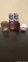 Group shot showing all tins, boxes and Poké Ball