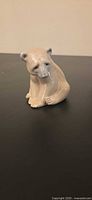Front view of seated polar bear figurine