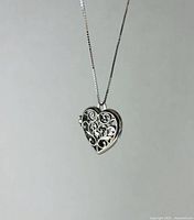 Heart locket hanging from box chain