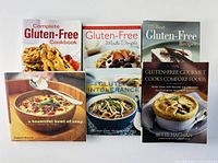 Front covers of all six cookbooks displayed