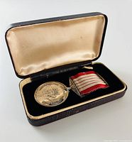 Medal with ribbon inside open presentation case