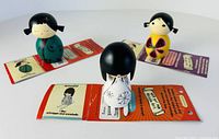 Three Momiji dolls on opened message cards, angled view
