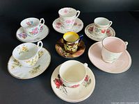 All seven teacup and saucer sets displayed together