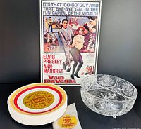 Group shot of metal sign, crystal bowl, and stack of paper plates